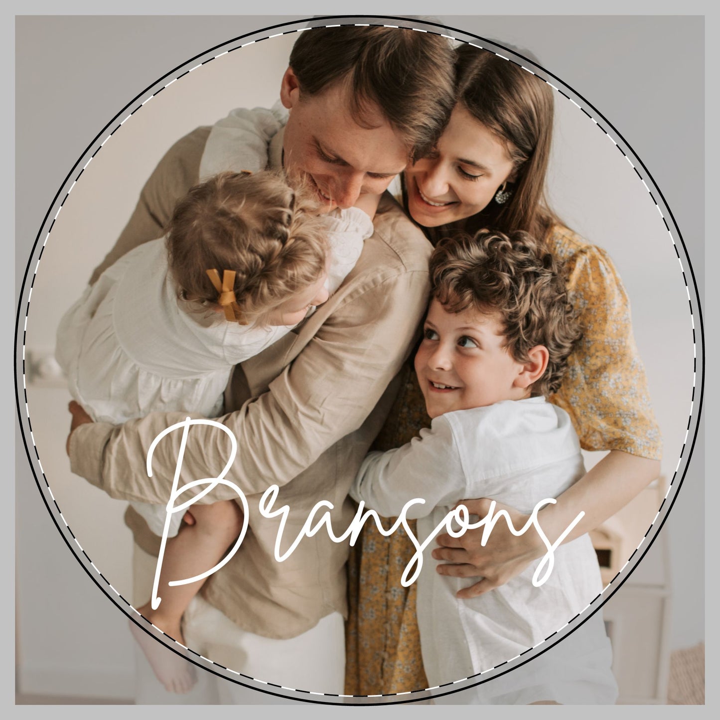 A circular family portrait and the word 'Bransons' in white script across the bottom, showing a father, mother, and two children in a warm indoor setting to be on a custom cutting board.