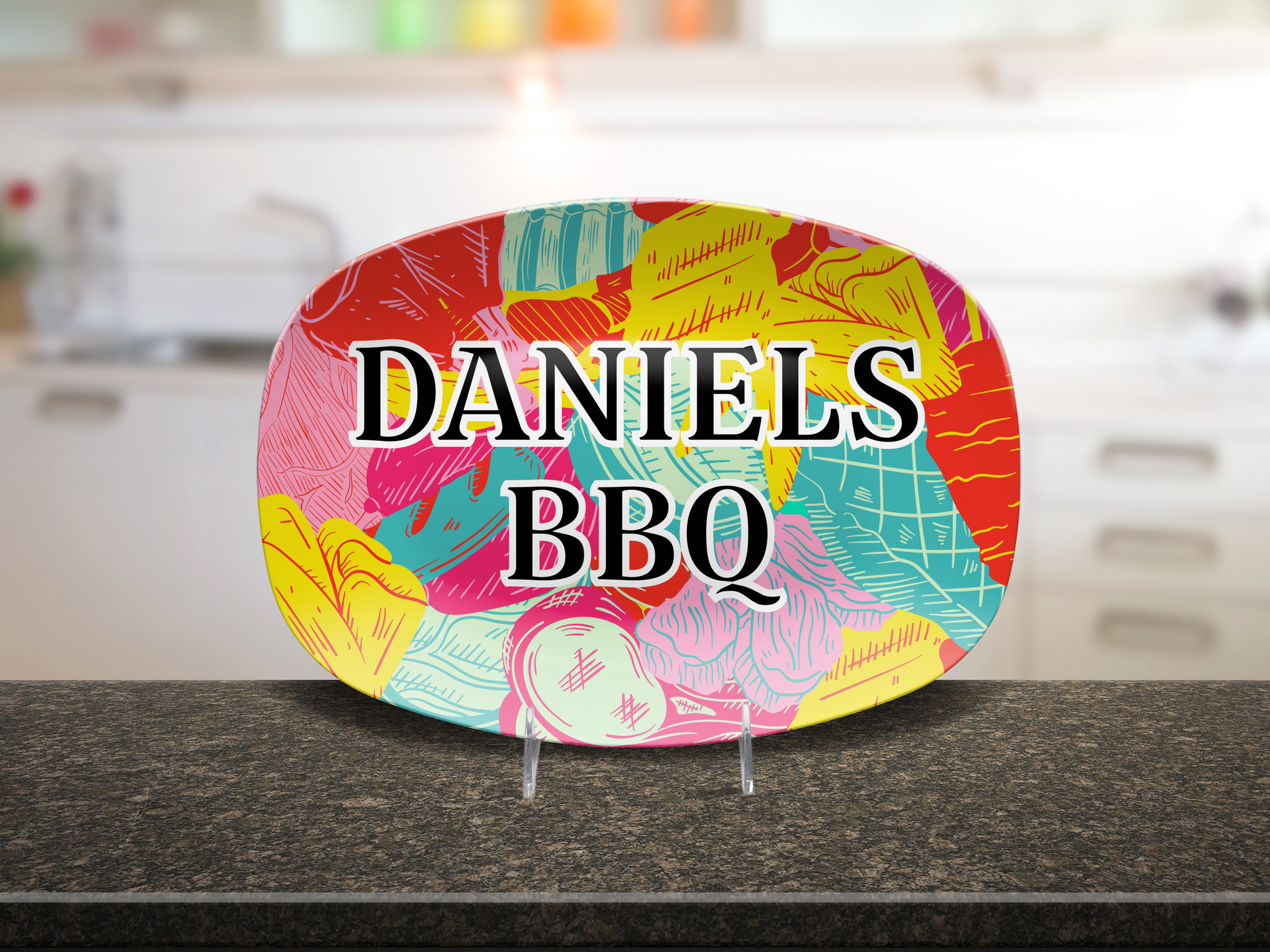 Colorful oval platter with 'DANIELS BBQ' text on a kitchen counter.