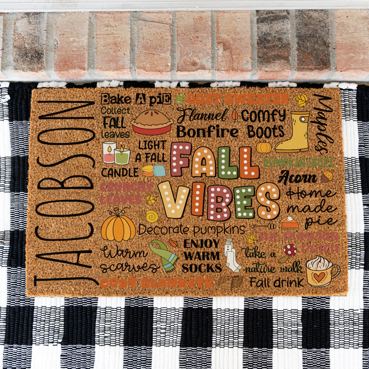 A doormat with a design of a collage so to speak of different fall words and images with the custom name JACOBSON on the far left.