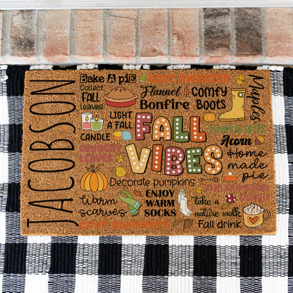 A doormat with a design of a collage so to speak of different fall words and images with the custom name JACOBSON on the far left.