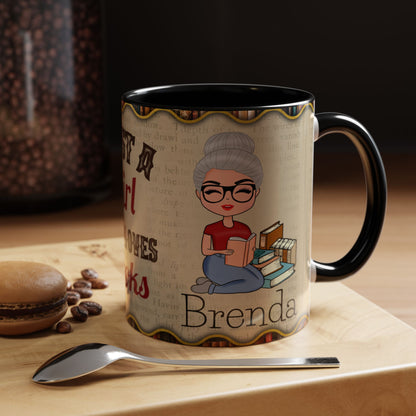 A personalized ceramic mug with a black handle and interior, featuring a cartoon illustration of a woman reading and the custom name 'Brenda' printed on a beige book-textured background. The mug sits on a wooden surface next to a spoon, coffee beans, and a macaron.