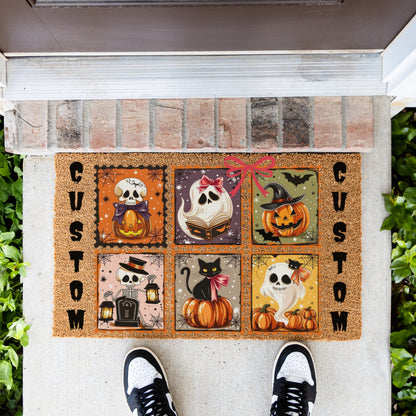 A custom Halloween doormat featuring six illustrated panels with pumpkins, ghosts, a black cat, bats, and lanterns, bordered by the word 'CUSTOM' on the left and right. The mat is shown on a concrete porch with a brick threshold, green plants on both sides, and a person's feet in black and white sneakers standing at the bottom.