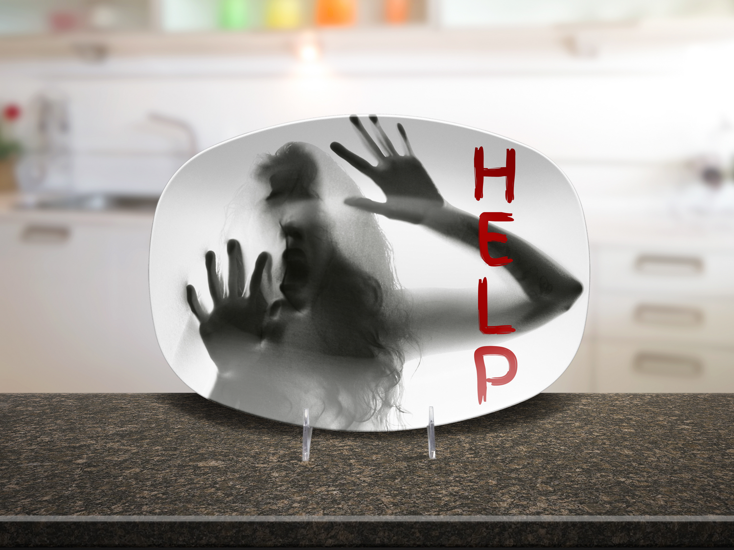 A decorative platter displayed on a kitchen counter, featuring a black-and-white photo of a woman with her hands pressed against the glass and the word 'HELP' in red vertical lettering.