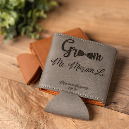 Gray leather can cooler with custom text 'Mr. Marvin L.' text and groom graphic on a wooden surface.