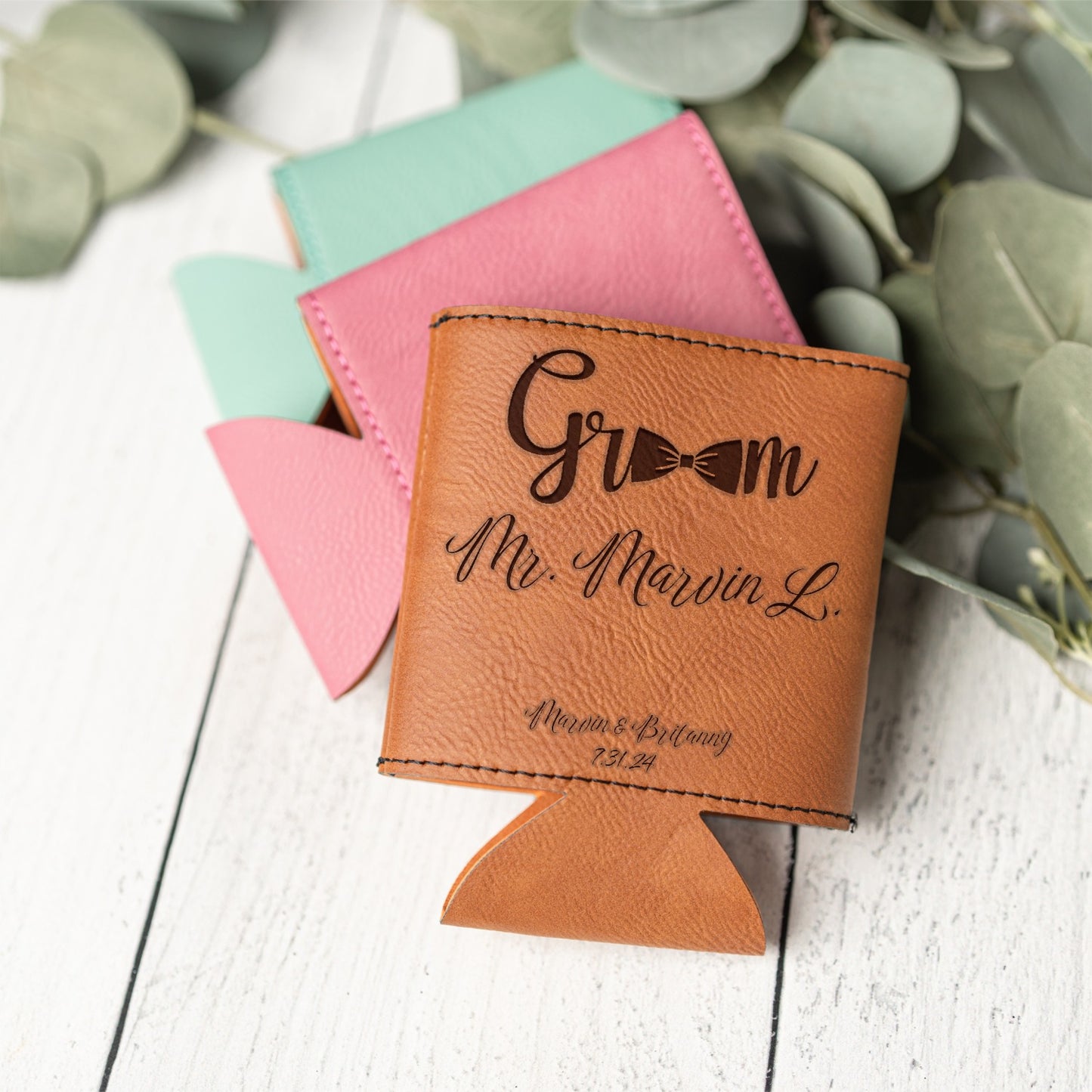A personalized tan leather can cooler with black script engraving reading 'Groom Mr. Marvin L.