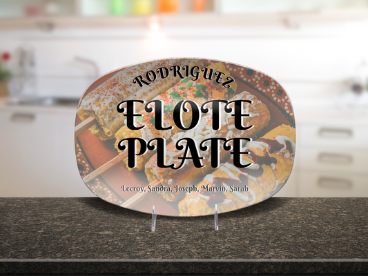 Decorative platter with 'Rodriguez Elote Plate and family members names' text on a kitchen counter.