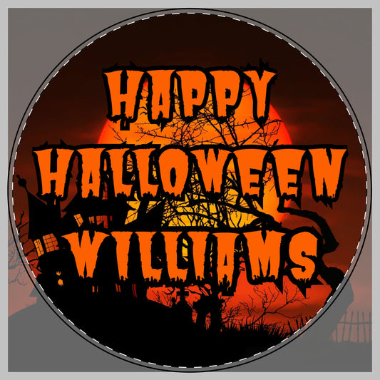 A circular Halloween-themed graphic with the phrase “HAPPY HALLOWEEN WILLIAMS” in large orange dripping letters over a spooky orange and black background with silhouettes of a haunted house, tree branches, and moon for a cutting board.